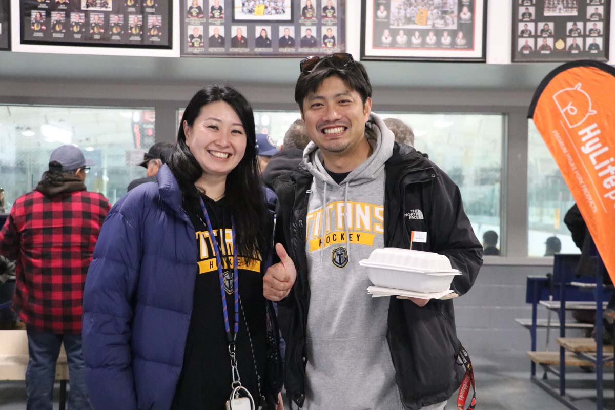 Fans celebrating at a sports event with HyLife sponsorship involvement