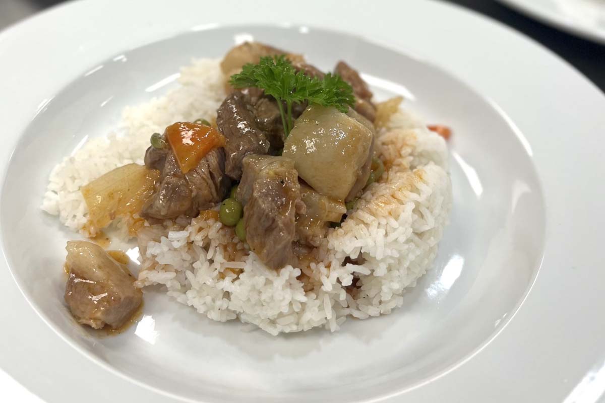 Employees sharing food and celebrating success at the workplace